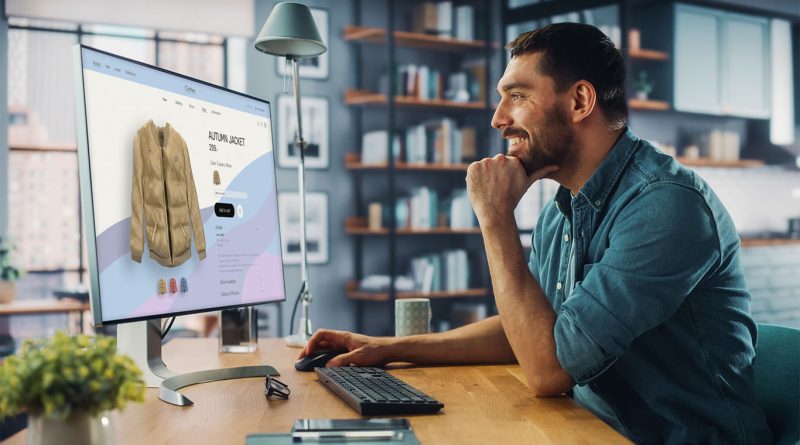 Image of a man at a desk scrolling through clothes on an online store to support fashion ecommerce article