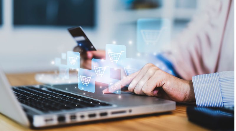 Image of someone typing on a laptop surrounded my shopping cart icons to support in-store retail shop article