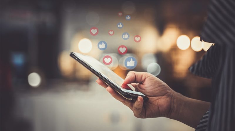 Image of someone scrolling a mobile phone with different social media icons floating out of it to support social media retail article