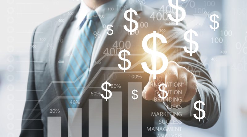 Image of a businessman in a suit pointing at a digital chart on a glass wall with dollar signs surrounding it to support kering article