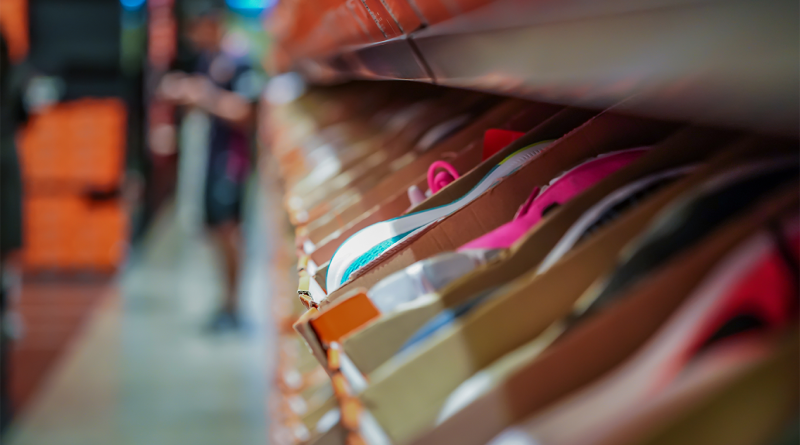 Boxes of shoes lined up on a shelf to support Nike's stock article