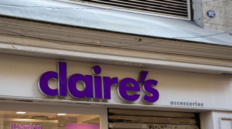 Exterior of a Claire’s retail store inside a shopping mall, with sale signs in the window.