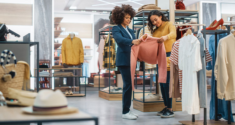 retail clothing store, where two individuals are engaged in shopping for apparel