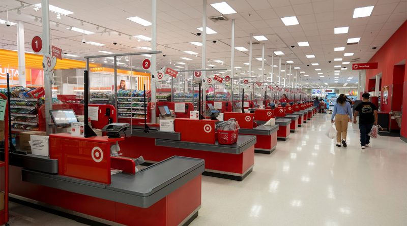 Silhouette of a departing CEO overlaid with a red downward stock chart inside an empty Target store