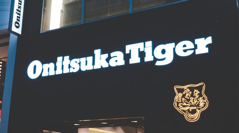 Yellow Onitsuka Tiger perfume bottles displayed with modern minimalist design